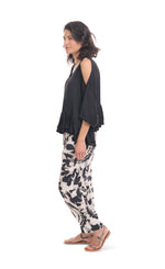 Load image into Gallery viewer, Left side full body view of a woman wearing the rhys ruffle blouse in black. This top has a cold shoulder, a round neck, 3/4 length sleeves and a ruffled hem. On the bottom the woman is wearing black and white printed pants.
