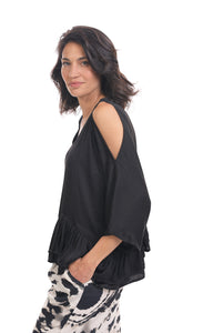 Left side top half view of a woman wearing the rhys ruffle blouse in black. This top has a cold shoulder, a round neck, 3/4 length sleeves and a ruffled hem. On the bottom the woman is wearing black and white printed pants.