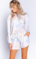 Load image into Gallery viewer, Front top half view of a woman wearing the pj salvage lounge life long sleeve top and the pj salvage lounge life short. The matching top and short are white with a ombre multicolored palm tree print.
