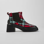 Load image into Gallery viewer, Outer side view of the camper blanket/rain multicolor boot. This boot has a chelsea style with elastic sides. The shoe has a red, black, and blue plaid print and a chunky black heel.
