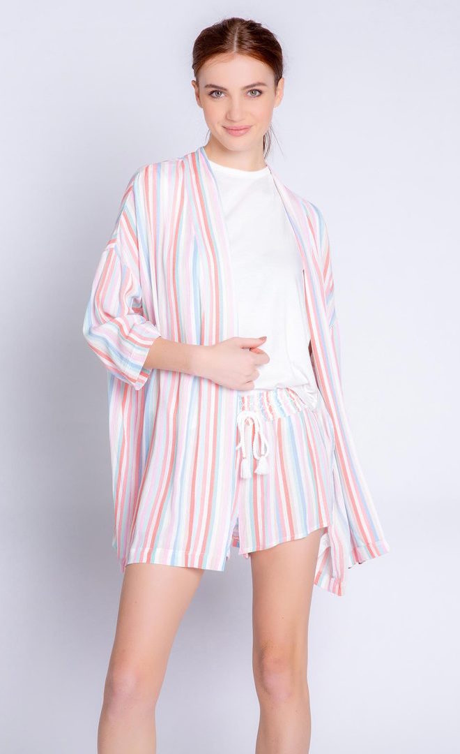 Front full body view of a woman wearing the pj salvage saturday morning stripe jacket. This jacket has multicolored stripes, a draped open front, and 3/4 length drop shoulder sleeves. on the bottom the model is wearing matching shorts.