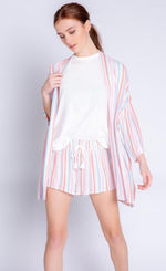 Load image into Gallery viewer, Front full body view of a woman wearing the pj salvage saturday morning stripe jacket. This jacket has multicolored stripes, a draped open front, and 3/4 length drop shoulder sleeves. on the bottom the model is wearing matching shorts.
