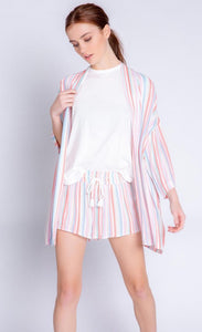 Front full body view of a woman wearing the pj salvage saturday morning stripe jacket. This jacket has multicolored stripes, a draped open front, and 3/4 length drop shoulder sleeves. on the bottom the model is wearing matching shorts.