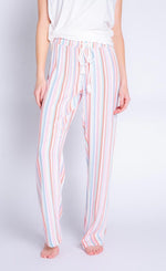 Load image into Gallery viewer, Front bottom half view of a woman wearing the saturday morning stripe pant. This pant is striped with a white adjustable tie waistband.
