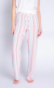 Front bottom half view of a woman wearing the saturday morning stripe pant. This pant is striped with a white adjustable tie waistband.