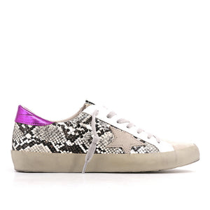 Outer side view of the shushop paloma sneaker. This sneaker is taupe with snake print sides, a fuschia pink, back and a lace up front 