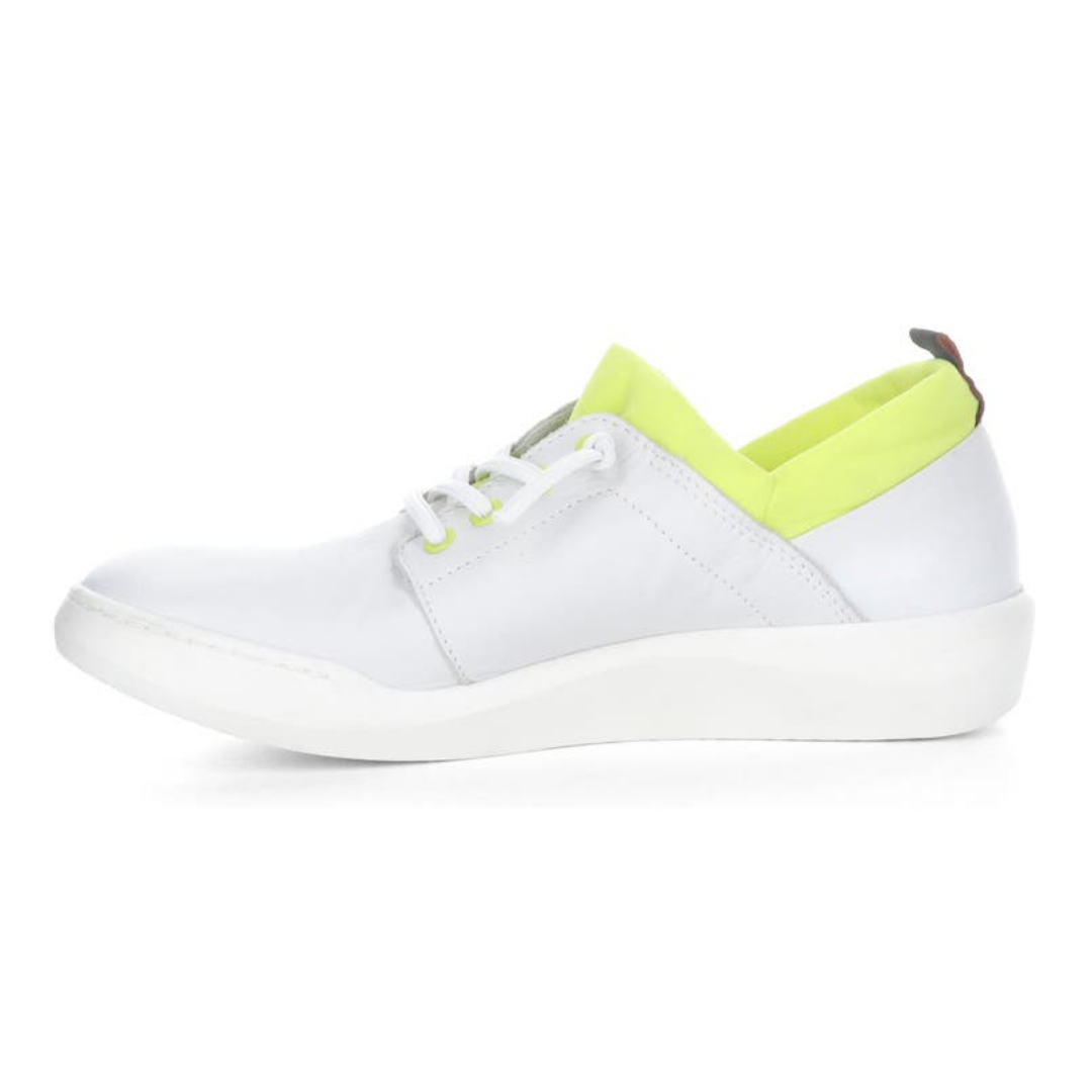 Inner view of the softino byra sneaker. This sneaker is white with a neon green layer of fabric around the opening. The shoes has non-functional white laces.