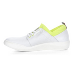 Load image into Gallery viewer, Inner view of the softino byra sneaker. This sneaker is white with a neon green layer of fabric around the opening. The shoes has non-functional white laces.
