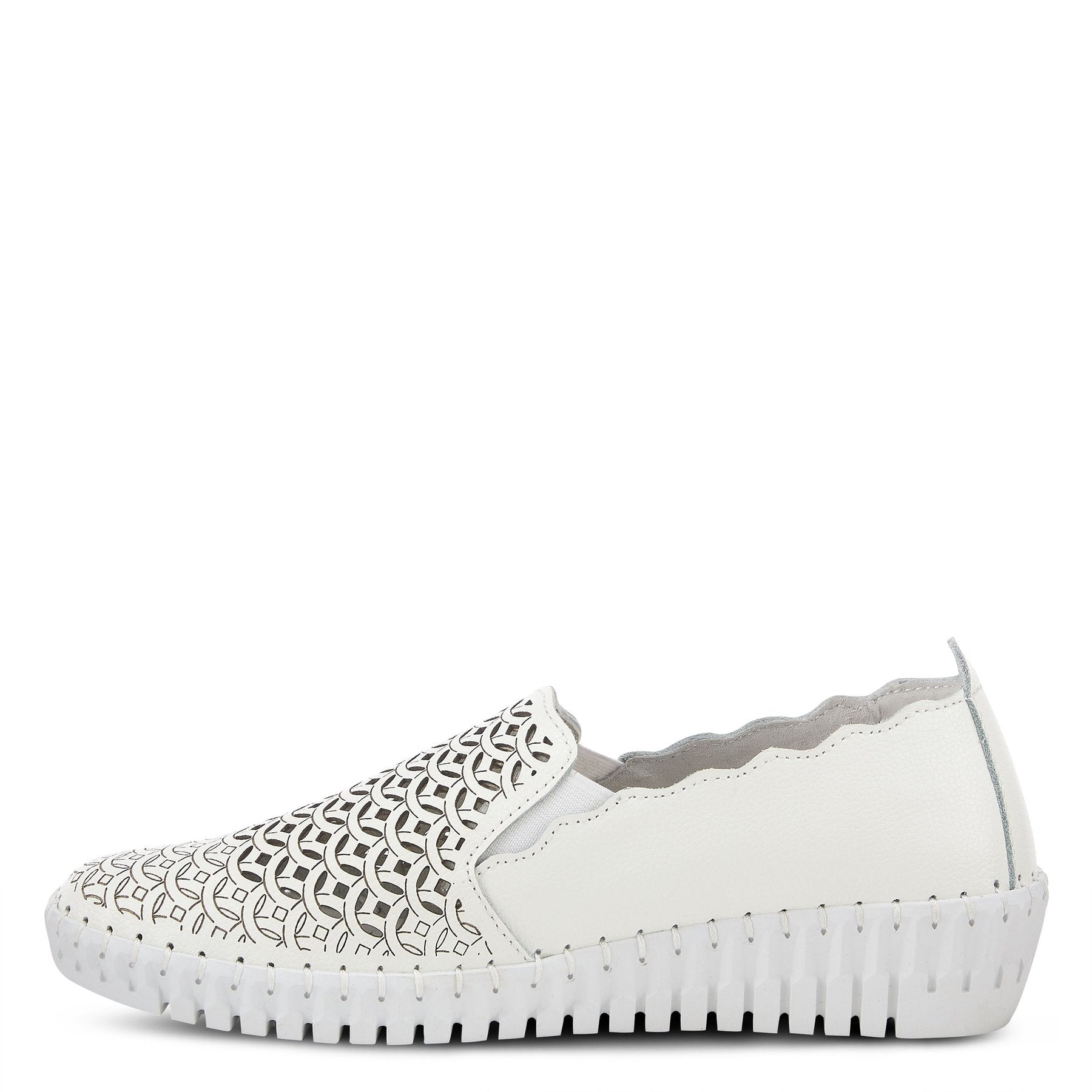 Inner side view of the spring step sasze sneaker. This all white slip on sneaker has a wedge heel, scalloped/wavy edges, and a laser-cut designed front.