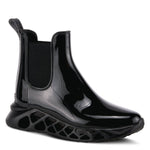 Load image into Gallery viewer, Outer side front view of the yasmine boot. This black boot is rubber with elastic side gores and rubber soles with holes.
