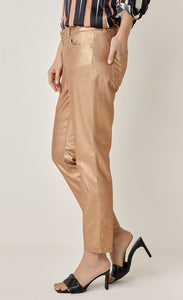 Left side bottom half view of a woman wearing a black, pink, and white striped shirt and the summum skinny foil coated trousers. These trousers are rose gold colored.