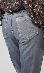 Back close up view of a woman wearing a black top with print and the summum straight blue daze denim pants. These jeans are blue-grey with a shimmer. They have two back pockets.