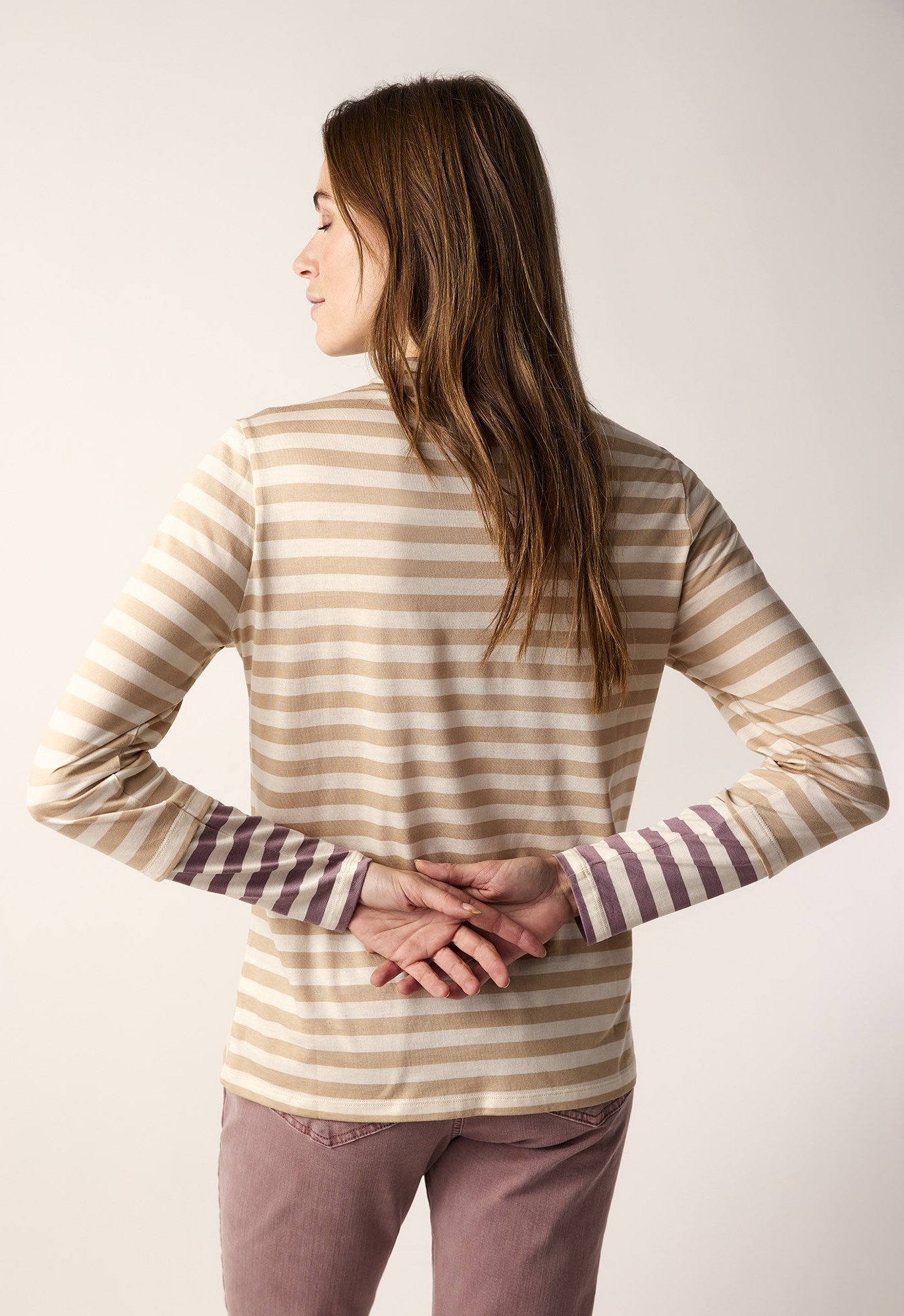 back top half view of the summum striped tone-on-tone shirt. This top has neutral brown stripes with contrasting wine stripes on the end of the long sleeves. The top also has a slight funnel neck.