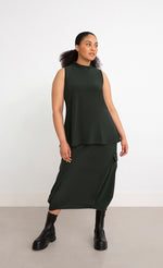 Load image into Gallery viewer, Front full body view of a woman wearing the Sympli Mock Neck Tank in the color seaweed. This top is dark green, sleeveless, and features a mock neck.
