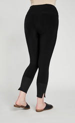 Load image into Gallery viewer, Back bottom half view of the sympli motion trim cuff legging. This legging is black with a ribbed cuff that has a tiny side slit.
