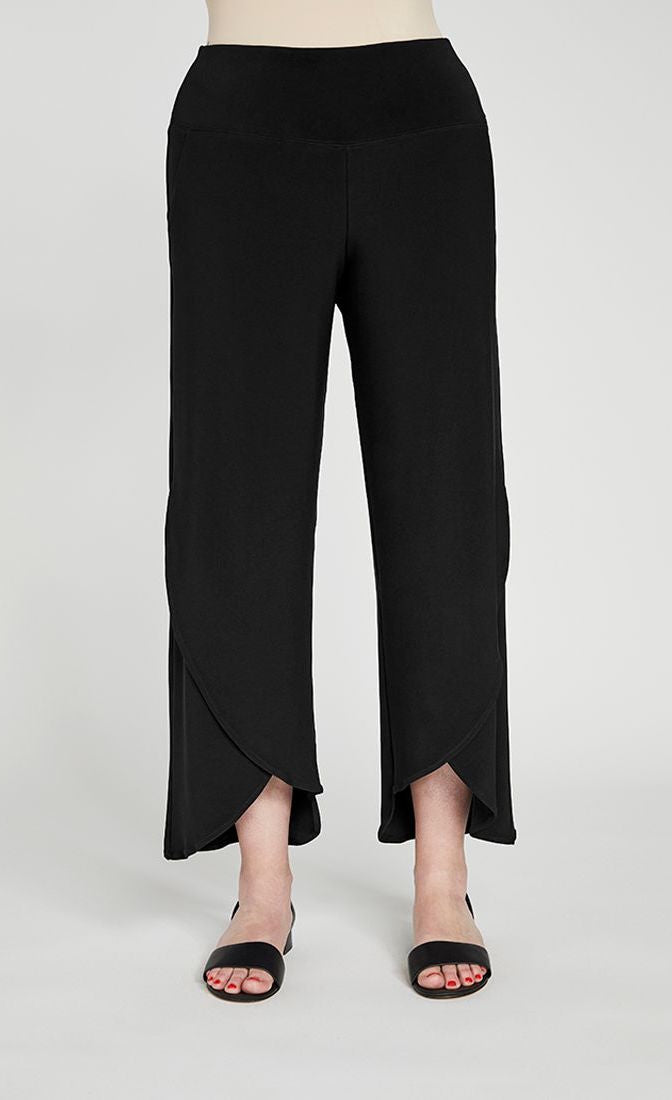 Front bottom half view of a woman wearing the sympli narrow rapt pant. These pants are black and feature side pockets, a wide waistband, a wrapped look near the hem, and a relaxed, straight silhouette