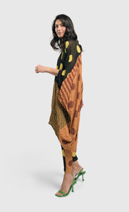 Left side full body view of a woman wearing the Alembika Miz Avery oversized tunic.