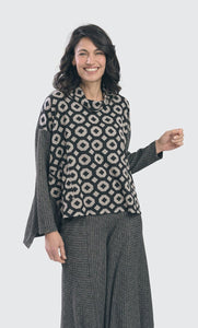 Front top half view of the alembika RILEY TRAPEZE TOP in a retro print/color. This print is black/grey with a cream geometric print on top. The drop shoulder long sleeves have a grey textured print similar to the swing back.