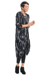 Load image into Gallery viewer, Front full body view of a woman wearing the tulip karma dress in black with a grey airbrush print. The dress has long sleeves and a gathered knot in the front.
