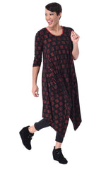 Load image into Gallery viewer, Front full body view of a woman wearing the tulip lexi tunic dress in the black with cherry cracker print all over it. This dress has long sleeves, a round neck, and a pointed hem.
