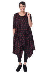 Load image into Gallery viewer, Front full body view of a woman wearing the tulip lexi tunic dress in black with cherry cracker print all over it. This dress has long sleeves, a round neck, and a pointed hem.
