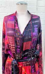 Load image into Gallery viewer, Front close up view of the unbreakable evolution amelie dress in the heart print. This print is red and purple. The dress has long sleeves and a v-neckline
