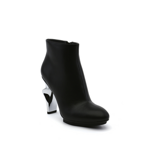 outer front side view of the united nude twirl bootie. This bootie is black with a metallic spiraling high heel.