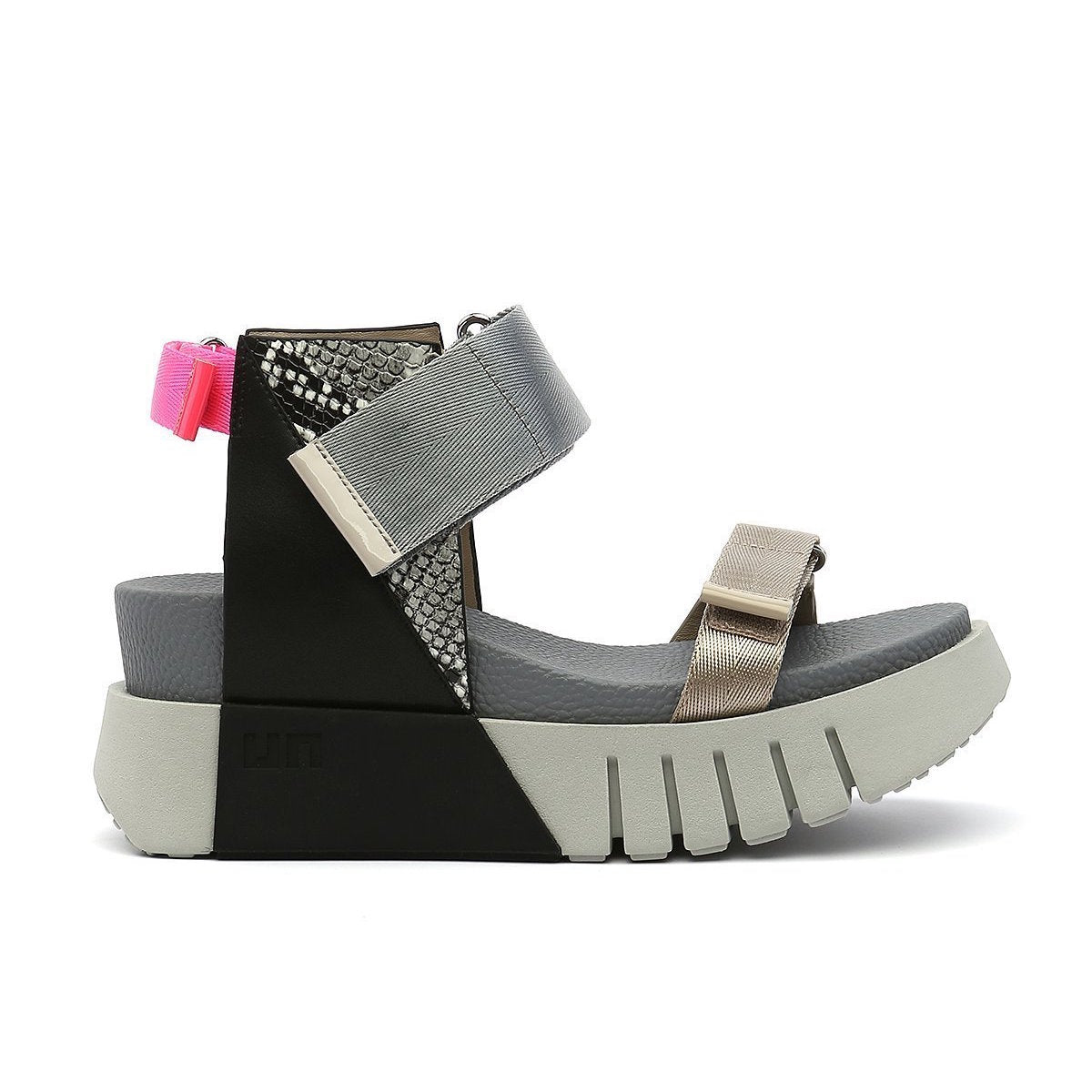 Outer view of the united nude delta run sandal. This sandal is grey with gold, black, snake print, and a touch of hot pink. The sandal has a white platform sole and adjustable back, ankle, and toe bed straps.