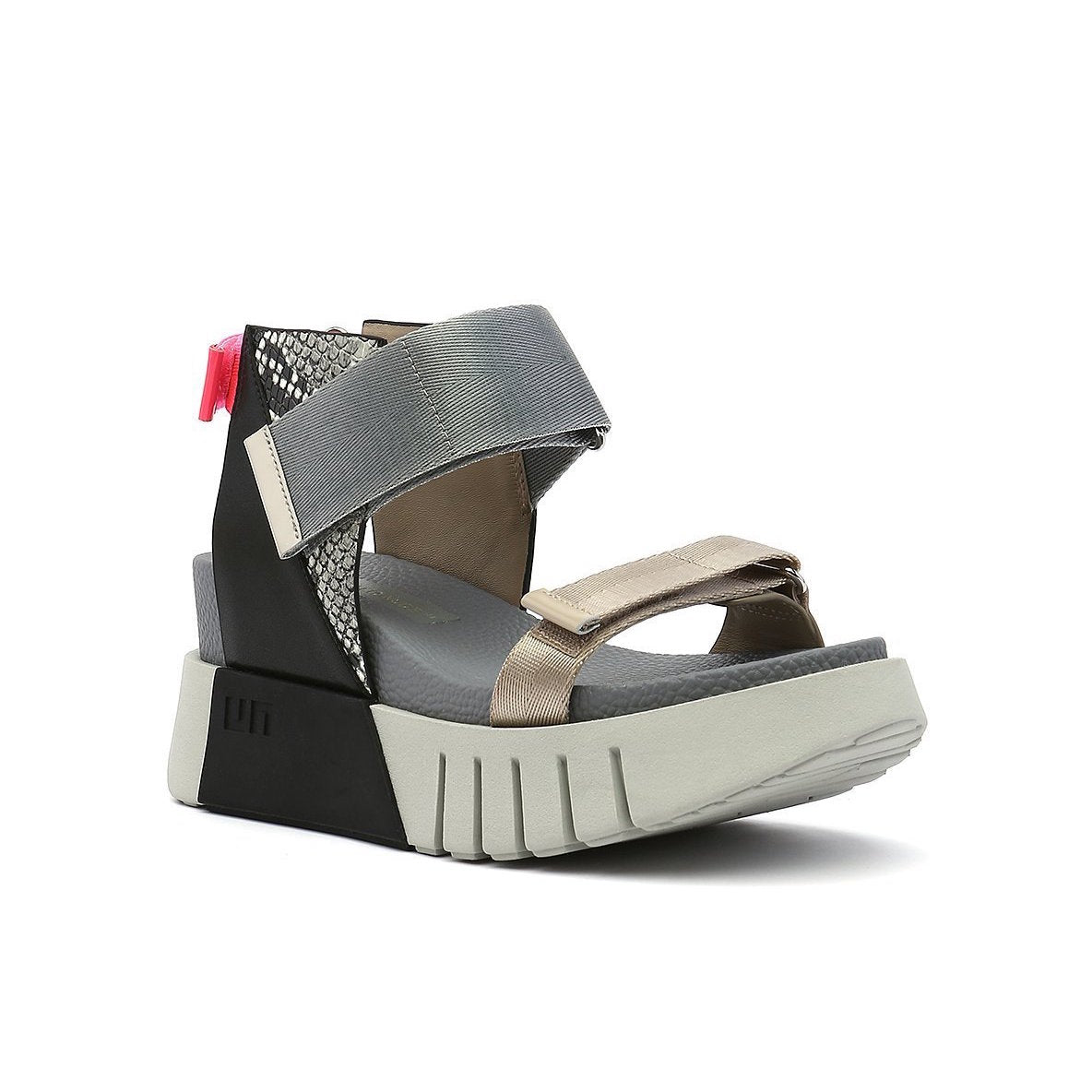 Outer front view of the united nude delta run sandal. This sandal is grey with gold, black, snake print, and a touch of hot pink. The sandal has a white platform sole and adjustable back, ankle, and toe bed straps.