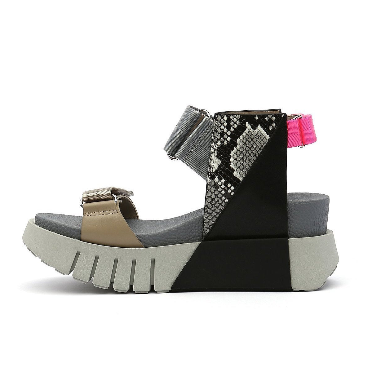 Inner view of the united nude delta run sandal. This sandal is grey with gold, black, snake print, and a touch of hot pink. The sandal has a white platform sole and adjustable back, ankle, and toe bed straps.