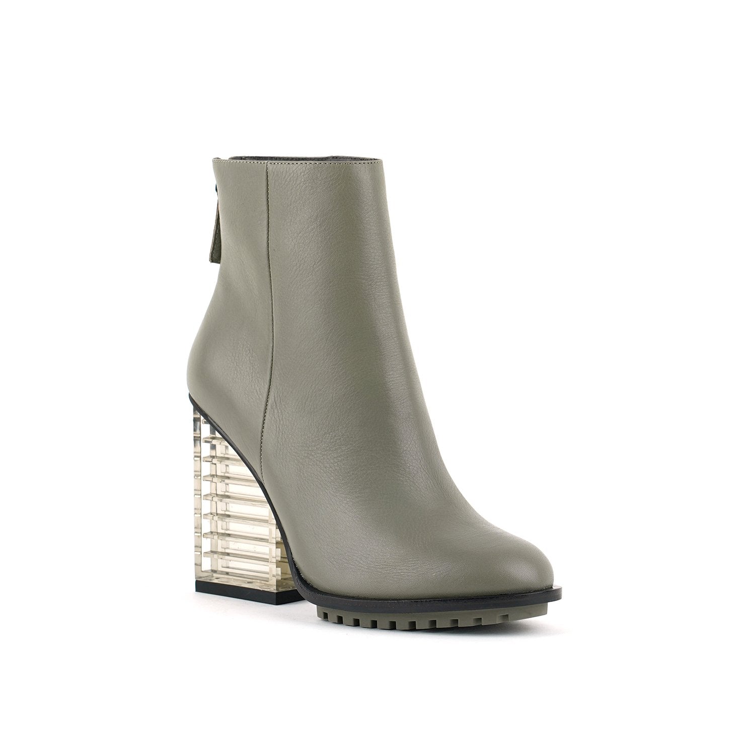 Outer side front view of the united nude hi rise bootie. This bootie is grey with a glass like see-through, block shaped high heel. The bootie is an ankle bootie with a back zipper.