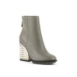 Load image into Gallery viewer, Outer side front view of the united nude hi rise bootie. This bootie is grey with a glass like see-through, block shaped high heel. The bootie is an ankle bootie with a back zipper.
