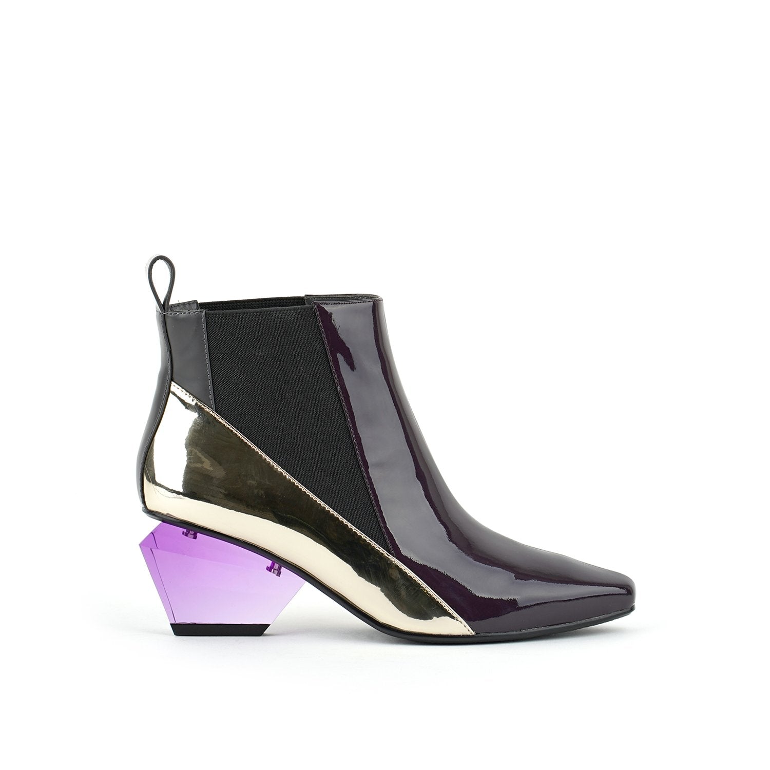 Outer side view of the united nude jacky h bootie. This bootie sits at the ankles. The top of the shoe is midnight brown. The bottom part of the shoe is silver. This bootie has elastic sides and a purple glass like heel.
