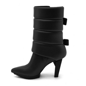 Left side view of the black united nude lev puffer bootie. This boot has padding around the calf with side buckles and a pointed toe bed.