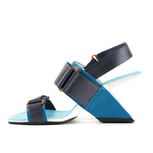 Inner view of the united nude loop run high heel sandal. This sandal is blue with a black back strap, a black strap over the instep, and a black strap over the toes.