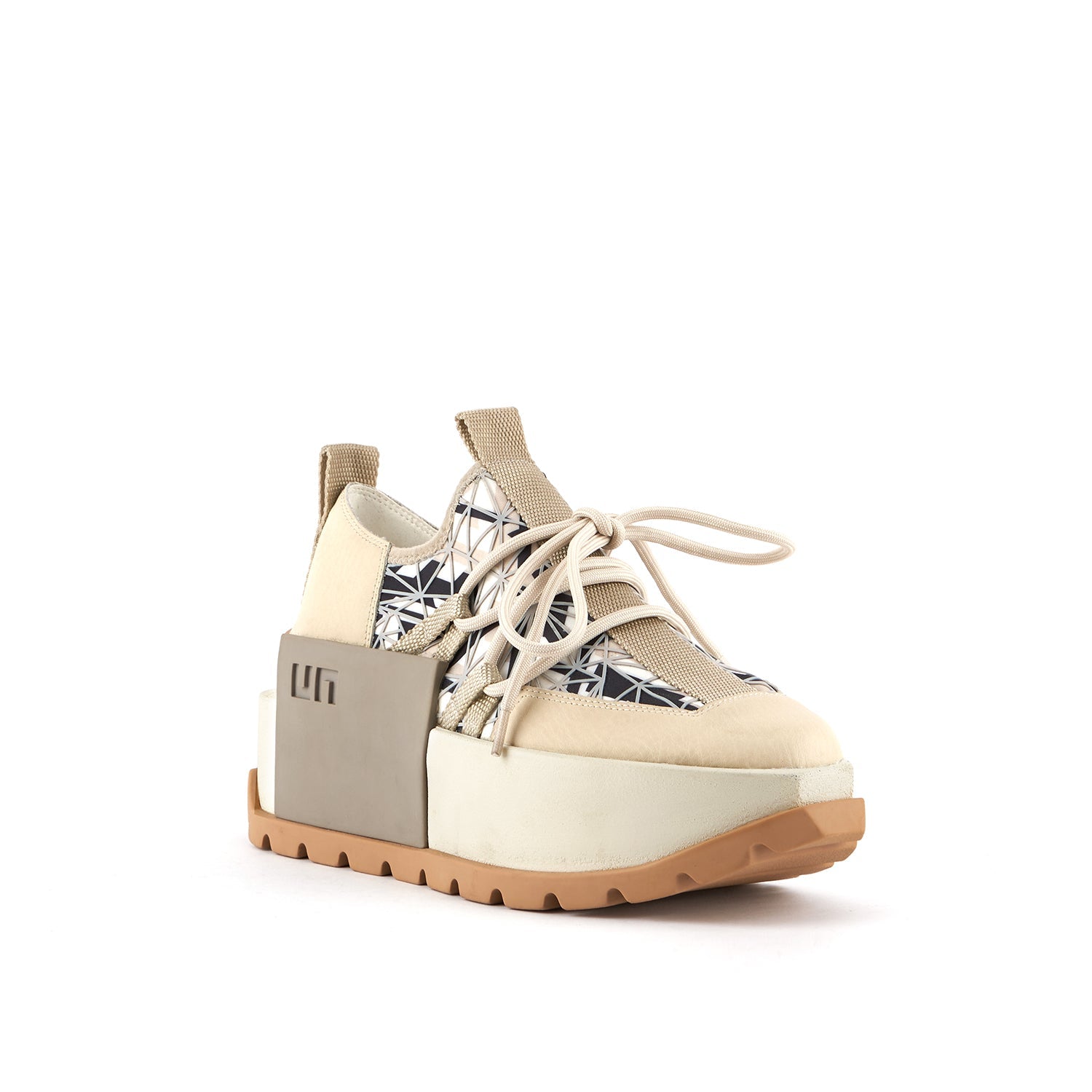 outer front side view of the united nude roko hype sneaker in the color beige/natural. This sneaker has a wedge platform sole, a lace up front, a black and white geometric design, and a decorative square on the outer side with the United Nude logo.