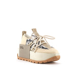 Load image into Gallery viewer, outer front side view of the united nude roko hype sneaker in the color beige/natural. This sneaker has a wedge platform sole, a lace up front, a black and white geometric design, and a decorative square on the outer side with the United Nude logo.
