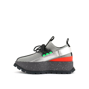 Inner side view of the united nude roko space sneaker. This sneaker is grey with a platform sole. The upper is a mesh-like fabric. The shoes has a back strap and a lace up front.