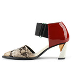 Load image into Gallery viewer, Inner view of the united nude vita dorsey mid viper. This sandal has a pointed toe in snake skin and a red patent leather covered with a wide nylon adjustable strap around the front of the ankle. This sandal has a mid-heel with a gold and silver accent.
