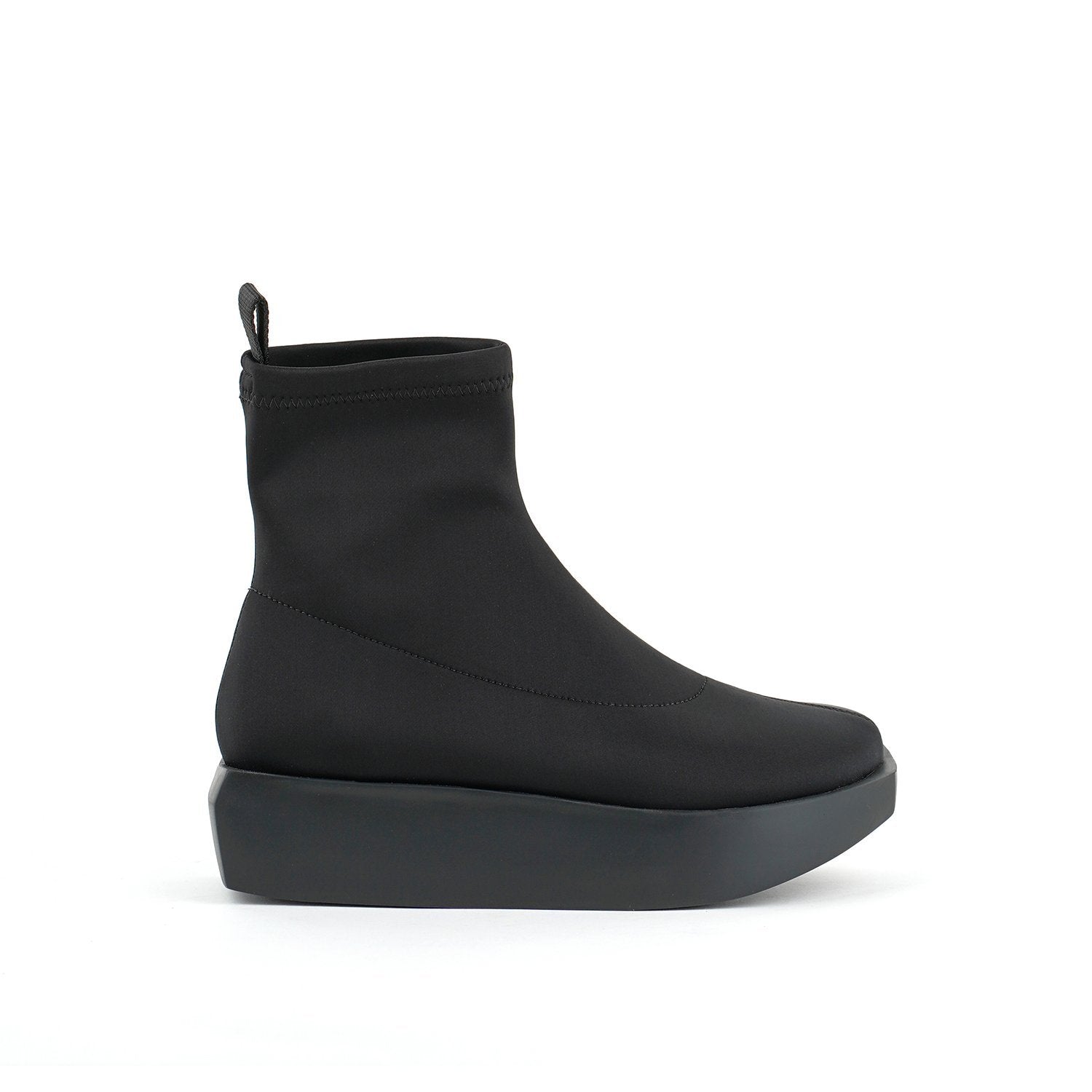 Outer side view of the united nude wa bootie lo. This bootie is black and minimal. It has a sock-like appearance with a black platform sole.