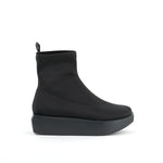 Load image into Gallery viewer, Outer side view of the united nude wa bootie lo. This bootie is black and minimal. It has a sock-like appearance with a black platform sole.
