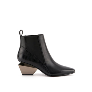 Outer side view of the united nude black jacky k bootie. This bootie is black with a chrome/brown metallic geometric heel. The boot has a pointed toe and and elastic gore on both sides of the shoe.