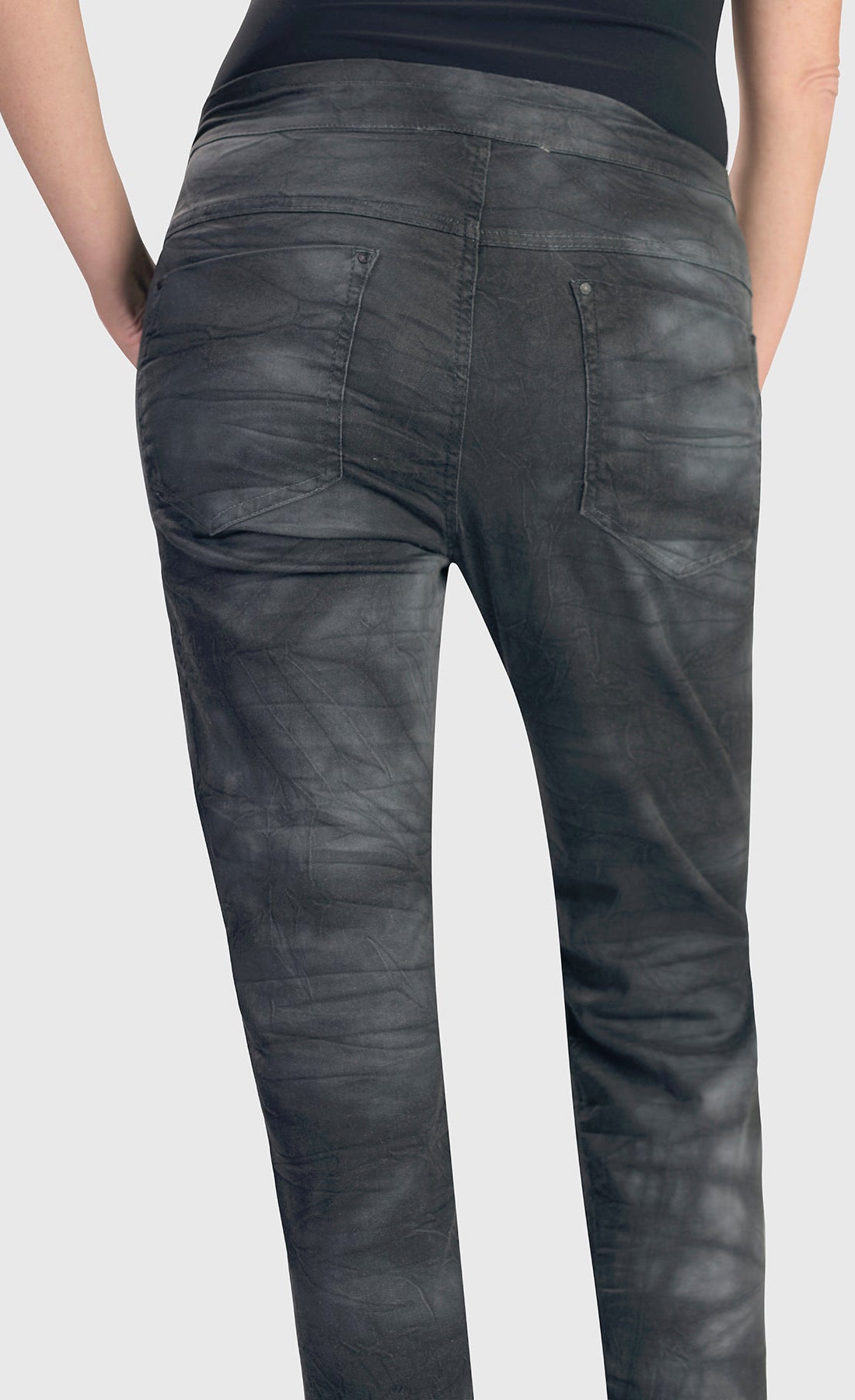 Back bottom half view of the alembika urban smoke iconic stretch jeans. These jeans have a relaxed slim fit and a washed grey print. The pant also has a yoked back and two back patch pockets.