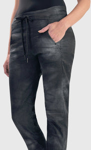 Front bottom half close up view of the alembika urban smoke iconic stretch jeans. These jeans have a relaxed slim fit and a drawstring tie waistband. The pant has a washed grey print and two front side pockets.
