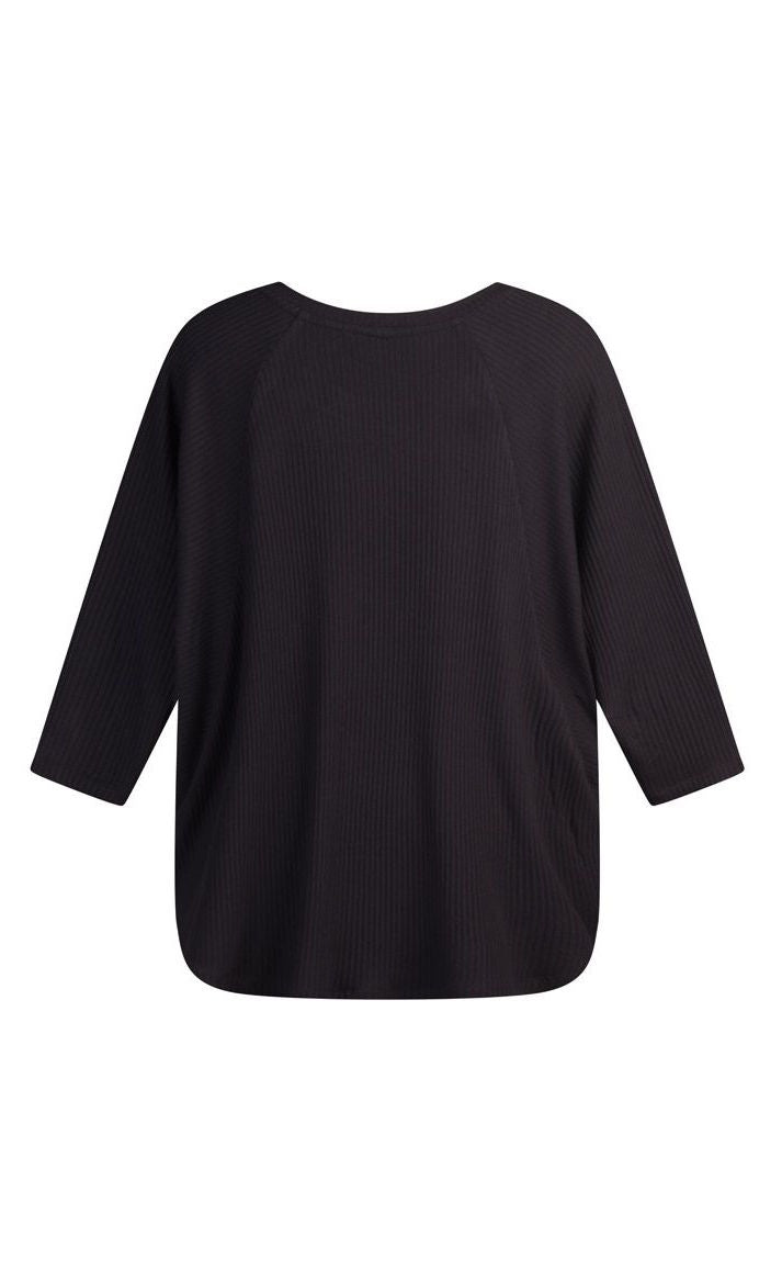 Back view of the alembika ribbed jersey top. This top has elbow length dolman sleeves, a rounded hem, and a round neck.