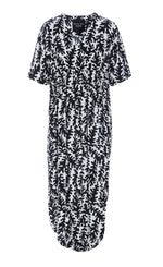Load image into Gallery viewer, Front view of the Bitte Kai Rand Graphic Leaves Long Dress. This dress features a black and white leaf print all over it. It has short sleeves, a v-neck, and a rounded hem.
