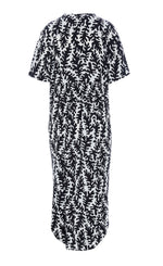 Load image into Gallery viewer, Back view of the Bitte Kai Rand Graphic Leaves Long Dress. This dress features a black and white leaf print all over it. It has short sleeves and a rounded hem.
