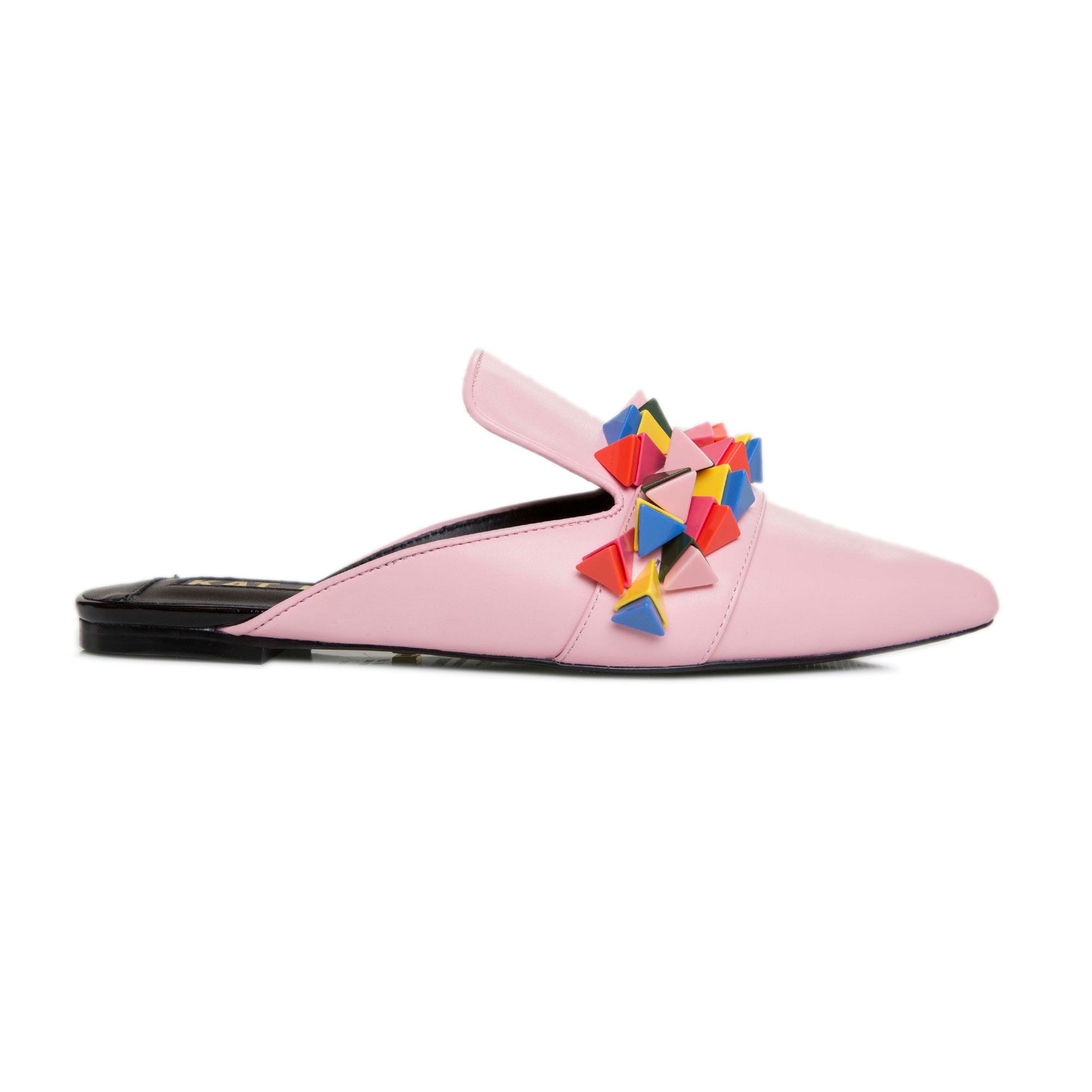Outer side view of the kat maconie issa mule. This slip on mule is pink with multicolored tiny pyramid shaped decorations on the upper. The shoe has a pointed toe.