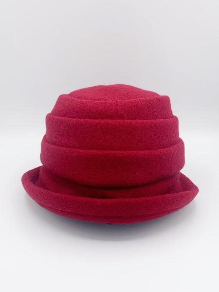 Front view of the lillie & cohoe beatrice hat. This hat is red with a tiered/folded crown and a rounded brim.