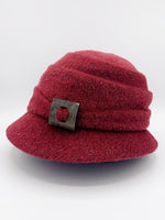 Load image into Gallery viewer, left side view of the lillie &amp; cohoe mohair Freda hat. This hat is red with a tiered crown and a front decorative wooden buckle/button
